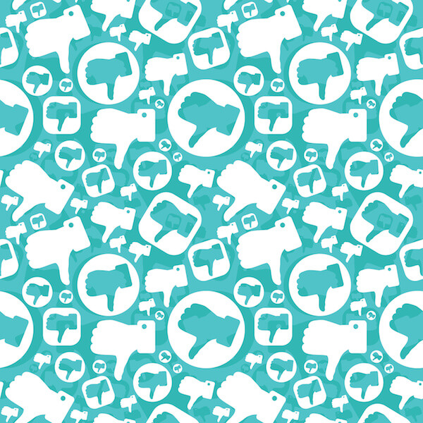 Dislike symbols on teal background, negative reviews, social media management